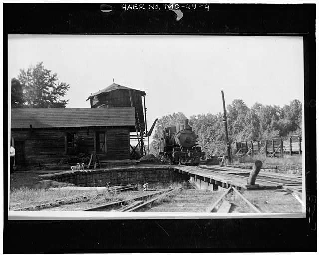 Chesapeake Beach Railroad Engine House, 21 Yost Place, Seat Pleasant, Prince George's County, Md. VIEW NORTH, YARD NORTH OF ENGINE HOUSE, SHOWING WATER TANK AND SHOP Photocopy of photograph, 1941 (Courtesy of Chesapeake Beach Railway Museum; L. W. Rice, photographer). LoC.